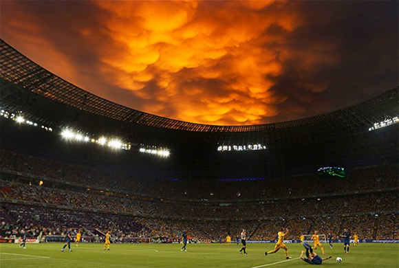 June 20, 2012: As the sun sets, the sky puts on an amazing show during a Euro 2012 soccer game between Ukraine & France. 